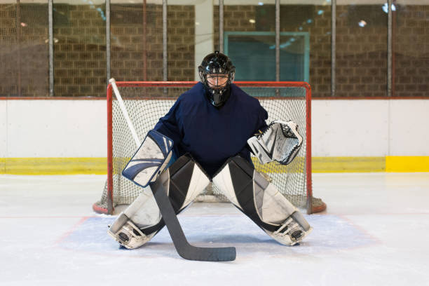 Ice Hockey Goaltender defending his goal stock photo
