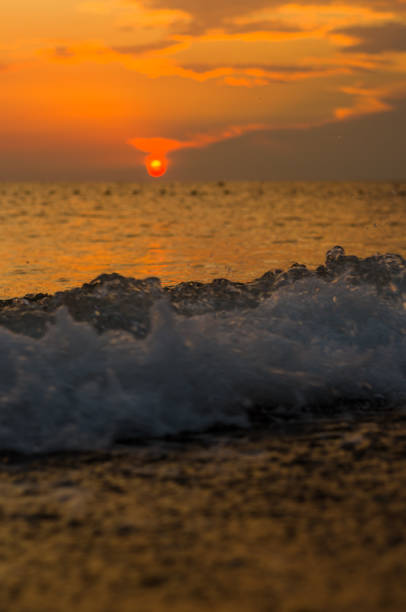 istock Amazing sea sunset on the pebble beach, the sun, waves, clouds 1136258961