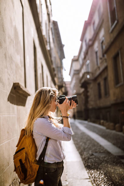 istock Female photographer taking photos with professional camera 1136260680