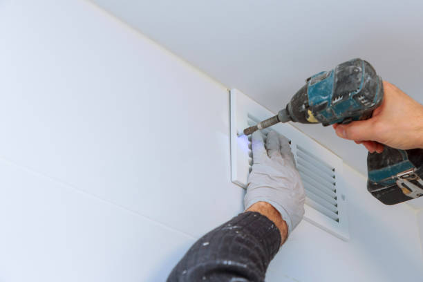 Close up man hand installing vent cover from ceiling