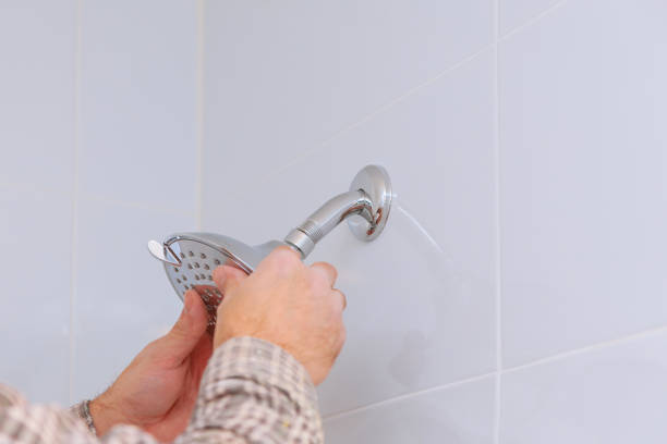 istock Workman repairing shower head in bathroom 1136261312