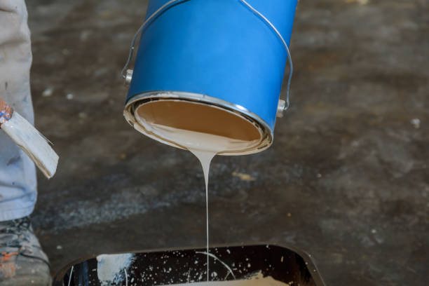 istock Close up on hands pouring paint into a paint tray 1136261339