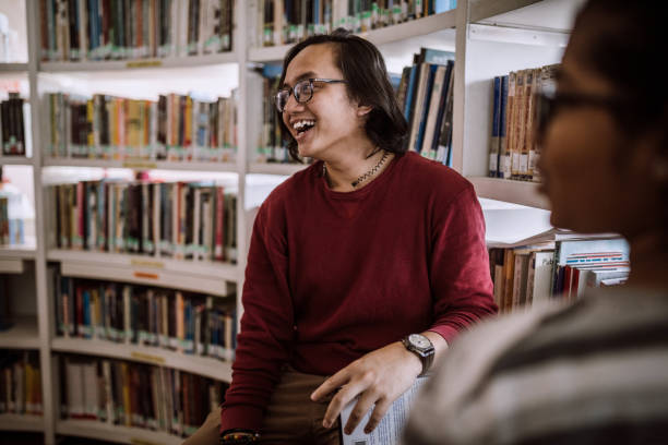 istock Indian woman and Malaysian man having friendly chat at library 1136261840