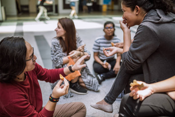 istock Students on lunch break eating snack outside 1136262386