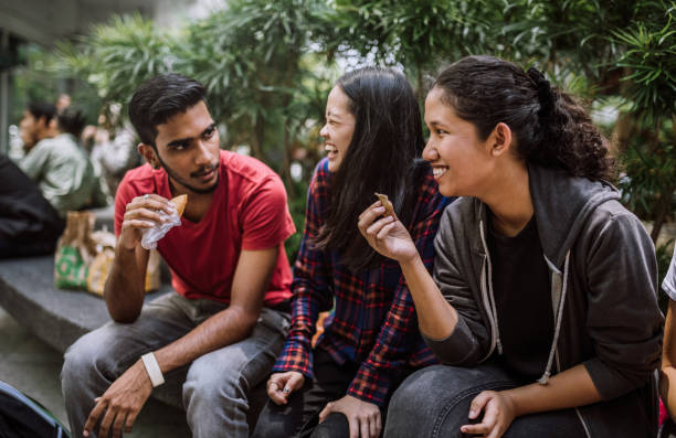 istock Students on lunch break eating snack outside 1136262489