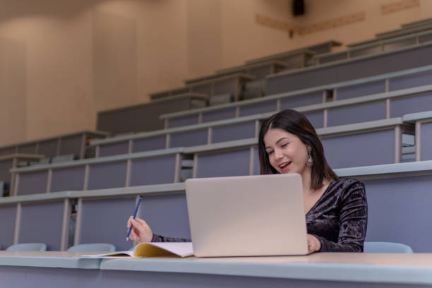 istock Woman working on laptop in a classroom 1136265095