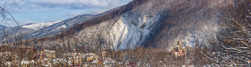 Winter landscape, panorama, banner - view of the temple of the Greek-Catholic Church on the background of the rock in valley Prut River the Carpathian Mountains, Yaremche, in Ukraine