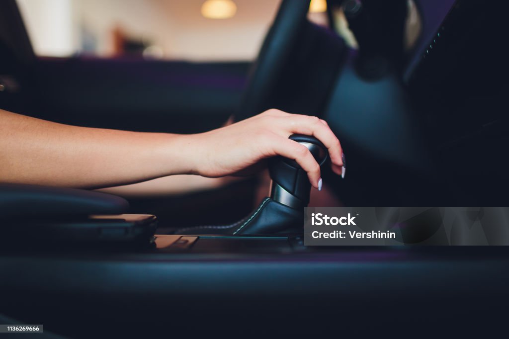 Female hand on automatic transmission lever, close up. Female hand on automatic transmission lever, close up Gearshift Stock Photo