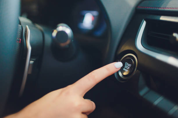 Car driver starting the engine keyless. Black. female hand. Car driver starting the engine keyless. Black. female hand ignition photos stock pictures, royalty-free photos & images