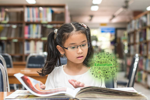 istock Innovative stem education and tree of knowledge concept with kid reading book in library 1136271369