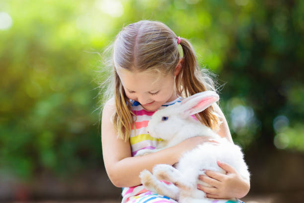 istock Child with rabbit. Easter bunny. Kids and pets. 1136271449