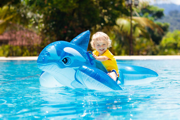 istock Child in swimming pool. Kid on inflatable float 1136273586
