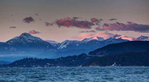 istock sea inlet and snow mountains at sunset 1136274212