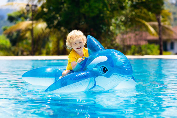 istock Child in swimming pool. Kid on inflatable float 1136274292