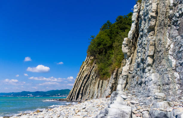 istock rocky sea shore with pebble beach, waves with foam 1136274959
