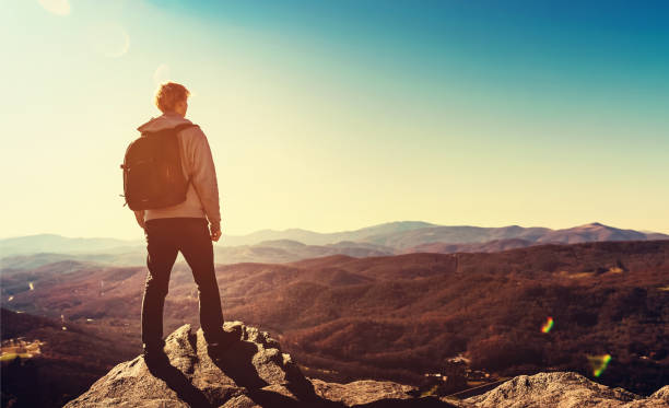 istock Man standing at the edge of a cliff 1136275101