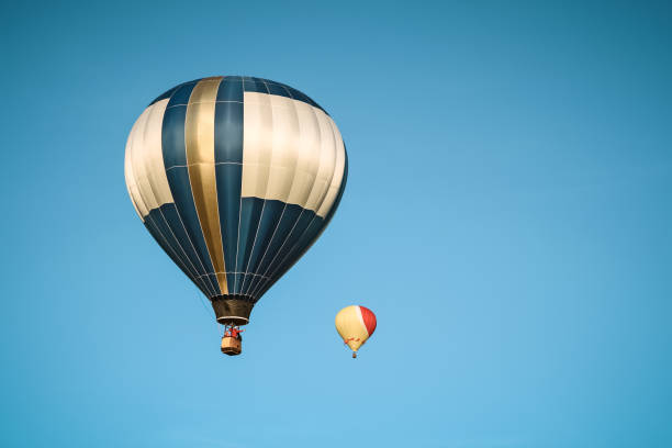 istock Two hot air balloons in the clear sky 1136282106