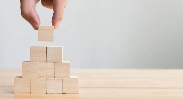 hand arranging wood block stacking as step stair. business concept for growth success process - block imagens e fotografias de stock