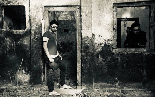 istock Two young men standing around an old house 1136284219