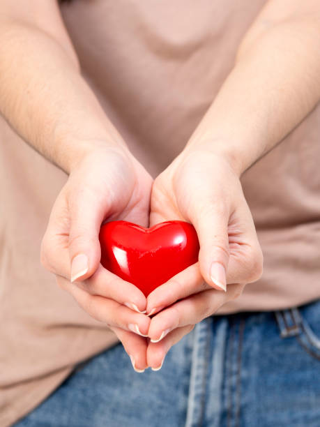 istock Woman Hand holding red heart concept 1136284612