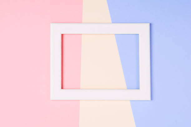 istock White wooden frame over pastel colorful paper background 1136284825