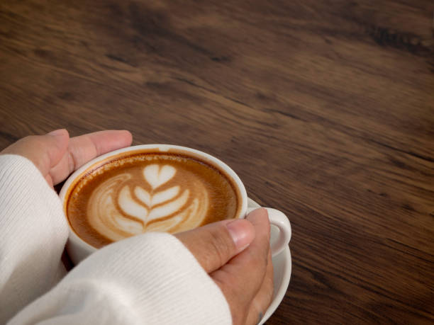 istock female hands holding cup of coffee 1136286205