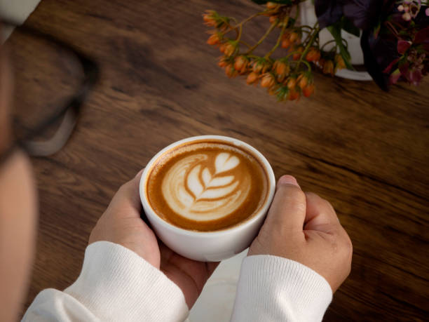 istock female hands holding cup of coffee 1136286310
