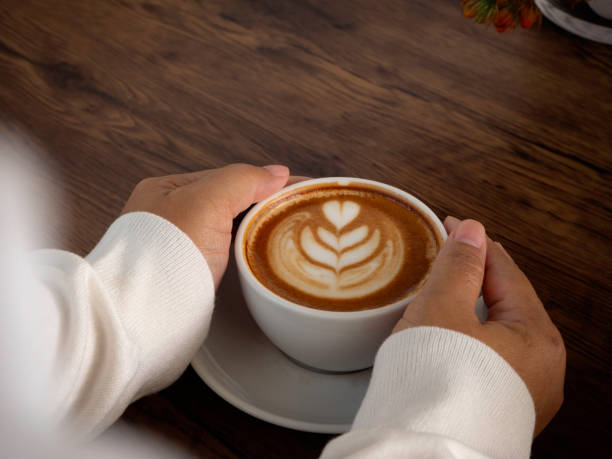istock female hands holding cup of coffee 1136286345