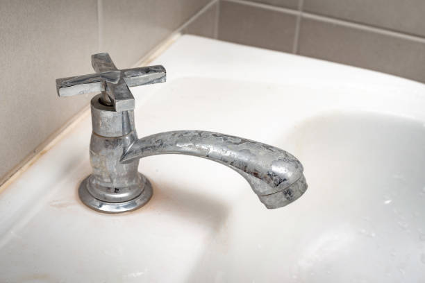 Dirty faucet with stain and limescale in bathroom