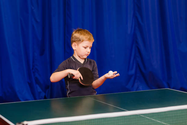 istock child throws the ball in table tennis 1136294251