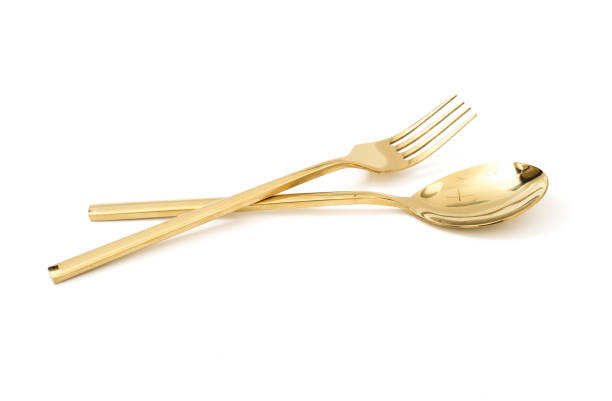 istock golden spoon and fork isolated on a white background 1136296220