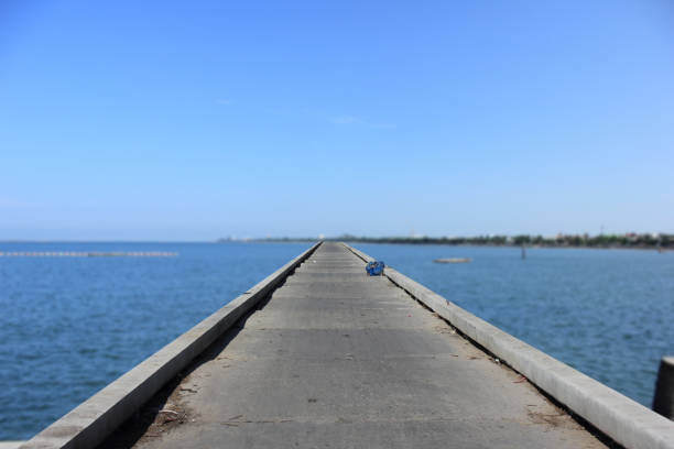 istock concrete bridge for walkway into the sea 1136298494