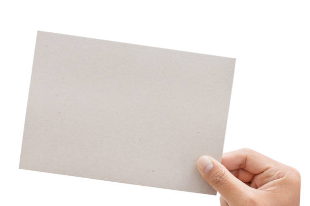 istock Male hand holding gray a blank paper - clipping paths. 1136298665