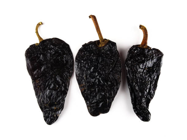 istock Isolated smoked dried peppers, Chile Ancho ,or dried Poblano pepper, Capsicum annuum, on a white background 1136299721