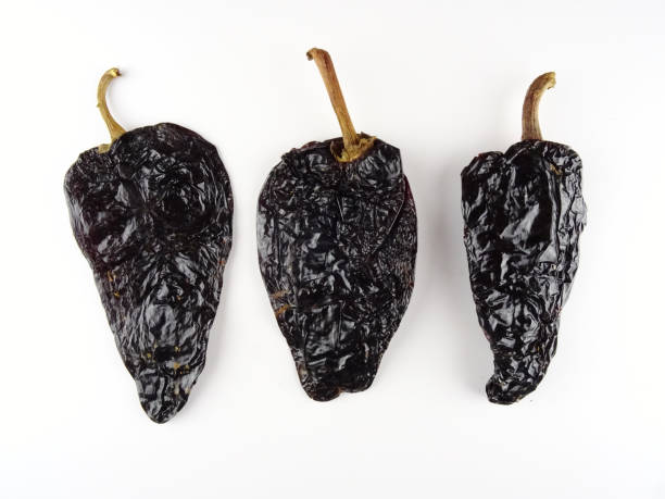 istock Isolated smoked dried peppers, Chile Ancho ,or dried Poblano pepper, Capsicum annuum, on a white background 1136299725