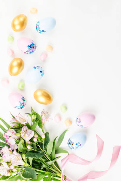 istock Festive Happy Easter background with decorated eggs, flowers, candy and ribbons in pastel colors on white. Copy space 1136305145
