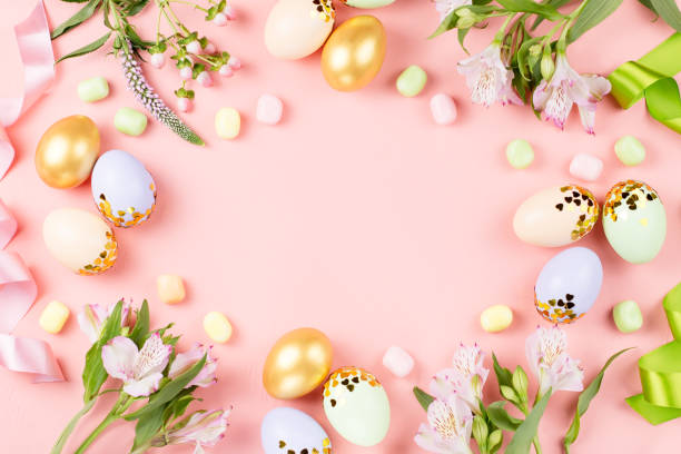 istock Festive Happy Easter background with decorated eggs, flowers, candy and ribbons in pastel colors on pink. Copy space 1136305154