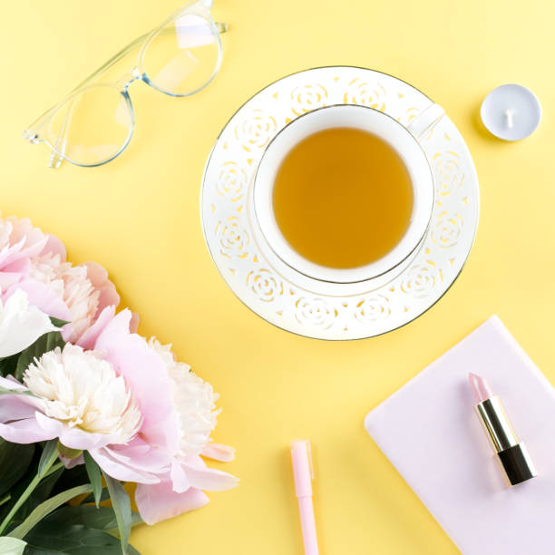 istock Beautiful cosmetics and flowers flat lay with note book, herbal tea on pastel background. 1136305308