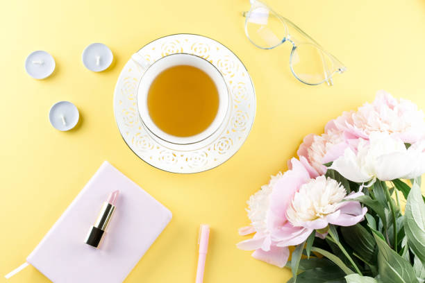 istock Beautiful cosmetics and flowers flat lay with note book, herbal tea on pastel background. 1136305309
