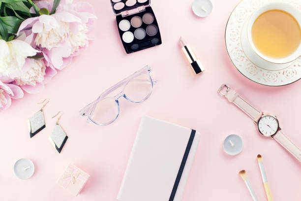 istock Beautiful cosmetics and flowers flat lay with note book, herbal tea on pastel background. 1136305312