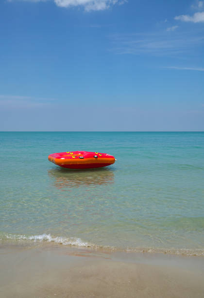 istock Red lilo floating in the blue sea 1136307389