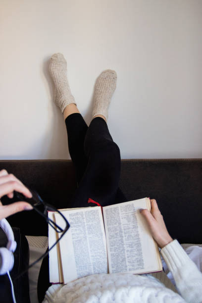 istock girl lying on bed and reading book 1136308158