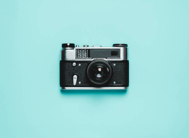 istock Vintage old photo camera on a blue background. Retro concept 1136308570