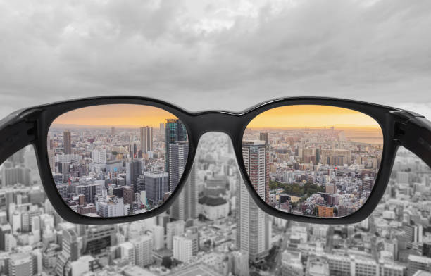 en regardant à travers les verres à la vue sur la ville au coucher du soleil. lunettes daltoniens, technologie smart glass - optics store photos et images de collection