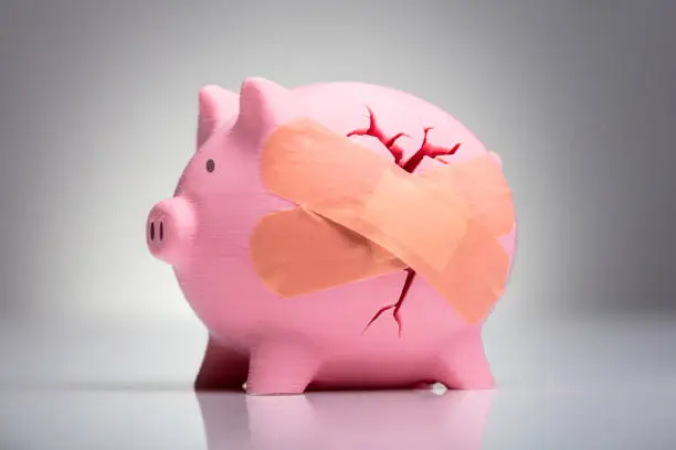 Photo of Broken Pink Piggybank With Bandage