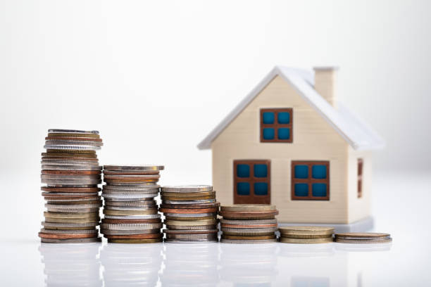 istock House Model Behind Stacked Coins 1136317269