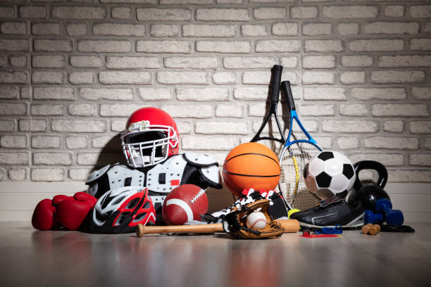 Sports Equipment On Floor Various Sport Equipment On Floor In Front Of Brick Wall sports clothing stock pictures, royalty-free photos & images