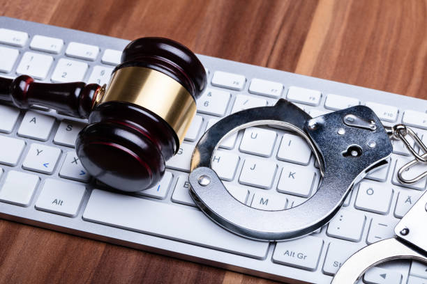 istock Gavel And Handcuffs On Keyboard 1136317699