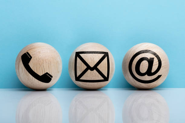 istock Three Wooden Ball With Contact Icon Against Blue Background 1136317764