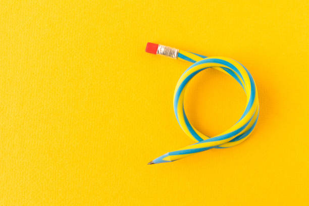 istock Flexible pencil . Isolated on yellow background. Bending pencil. 1136320727